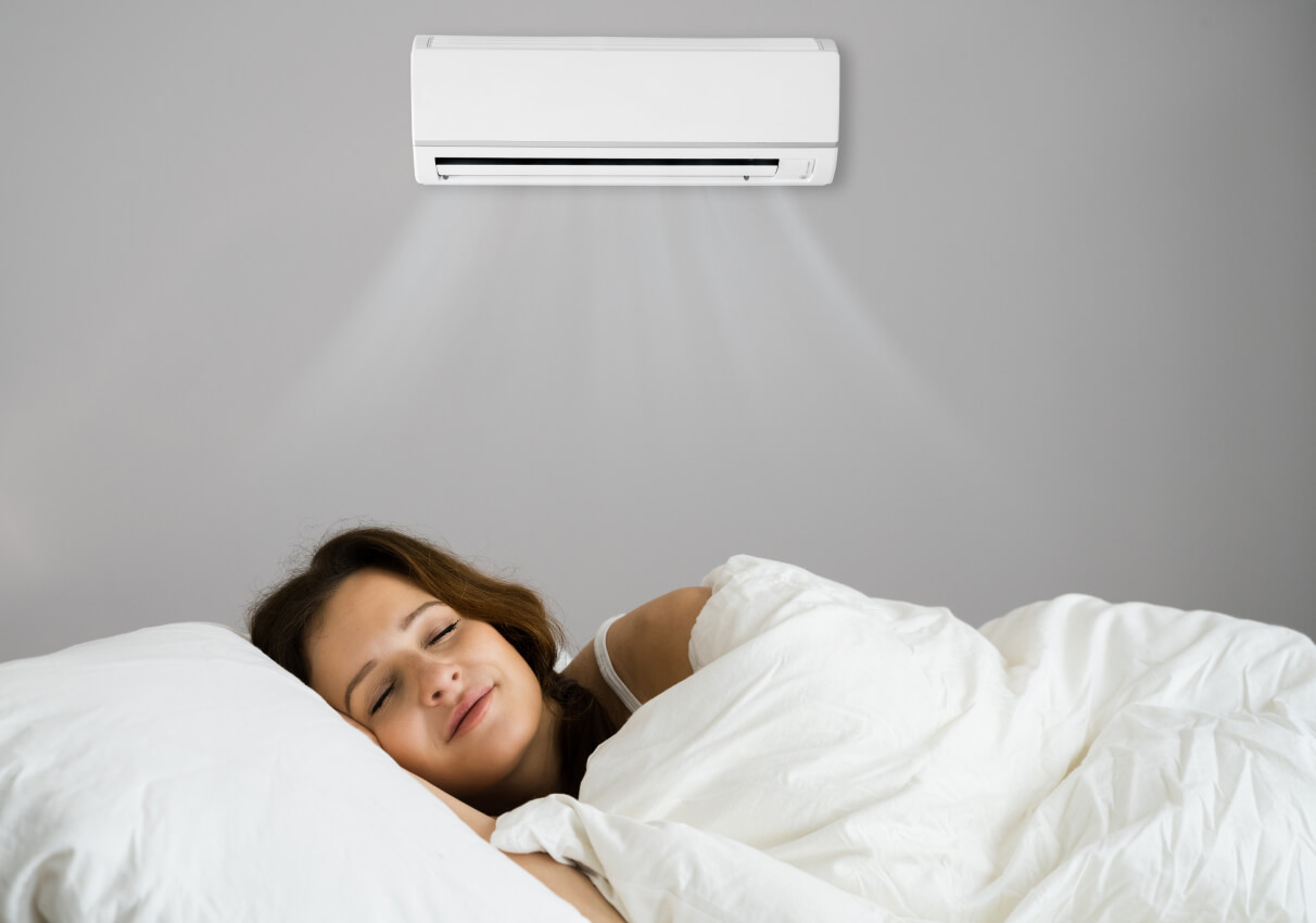 Woman sleeping with a Daikin air conditioner installed